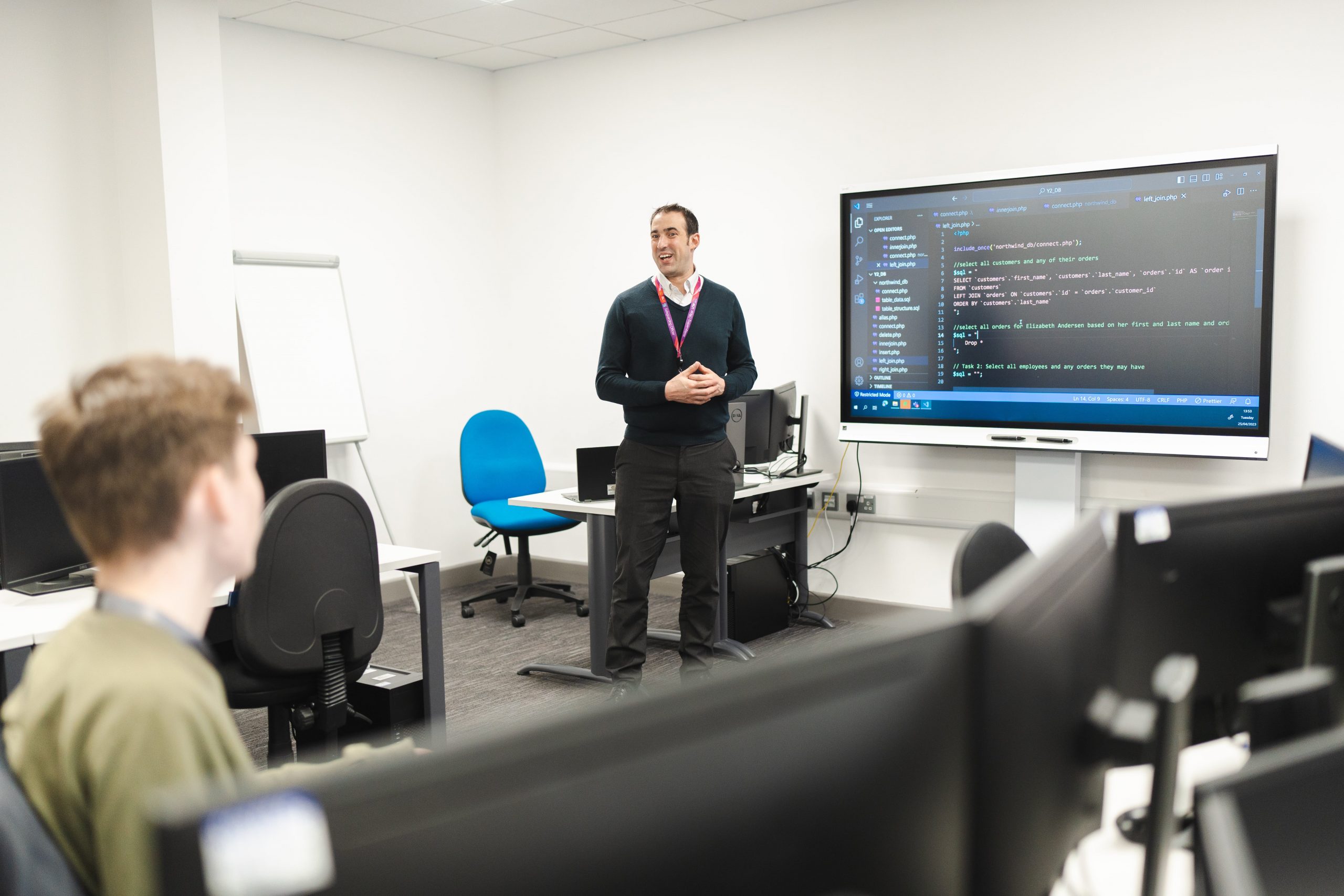 teacher standing in front of an interactive whiteboard