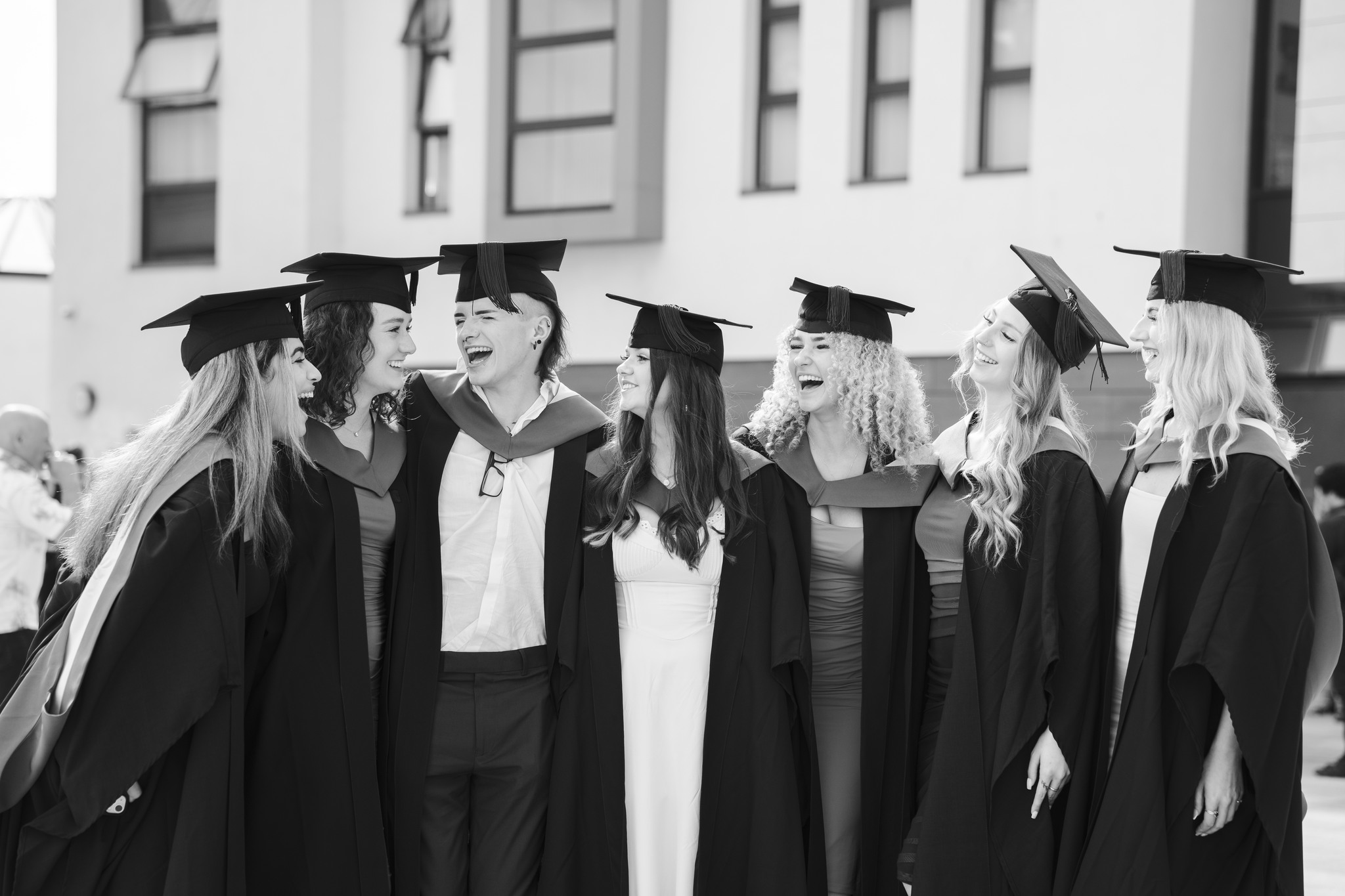 Graduates laughing at graduation