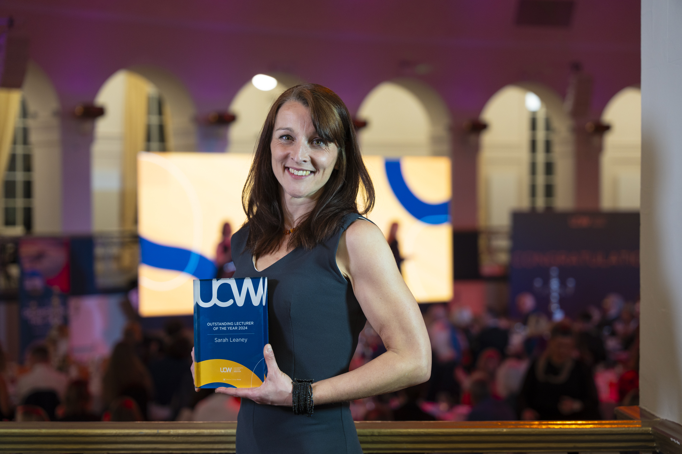 UCW lecturer Sarah posing with her award.