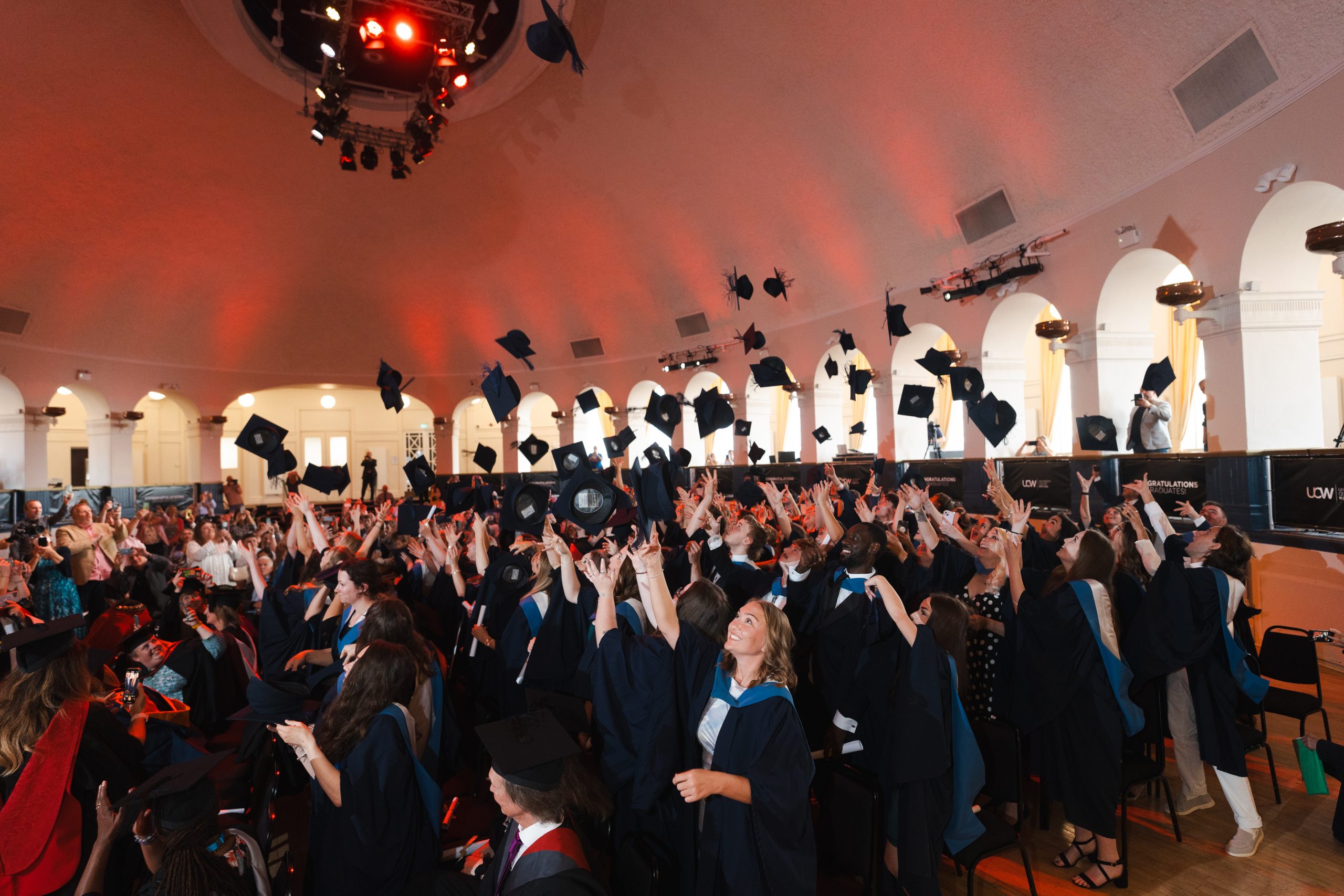 UCW graduates throwing their hats in the air