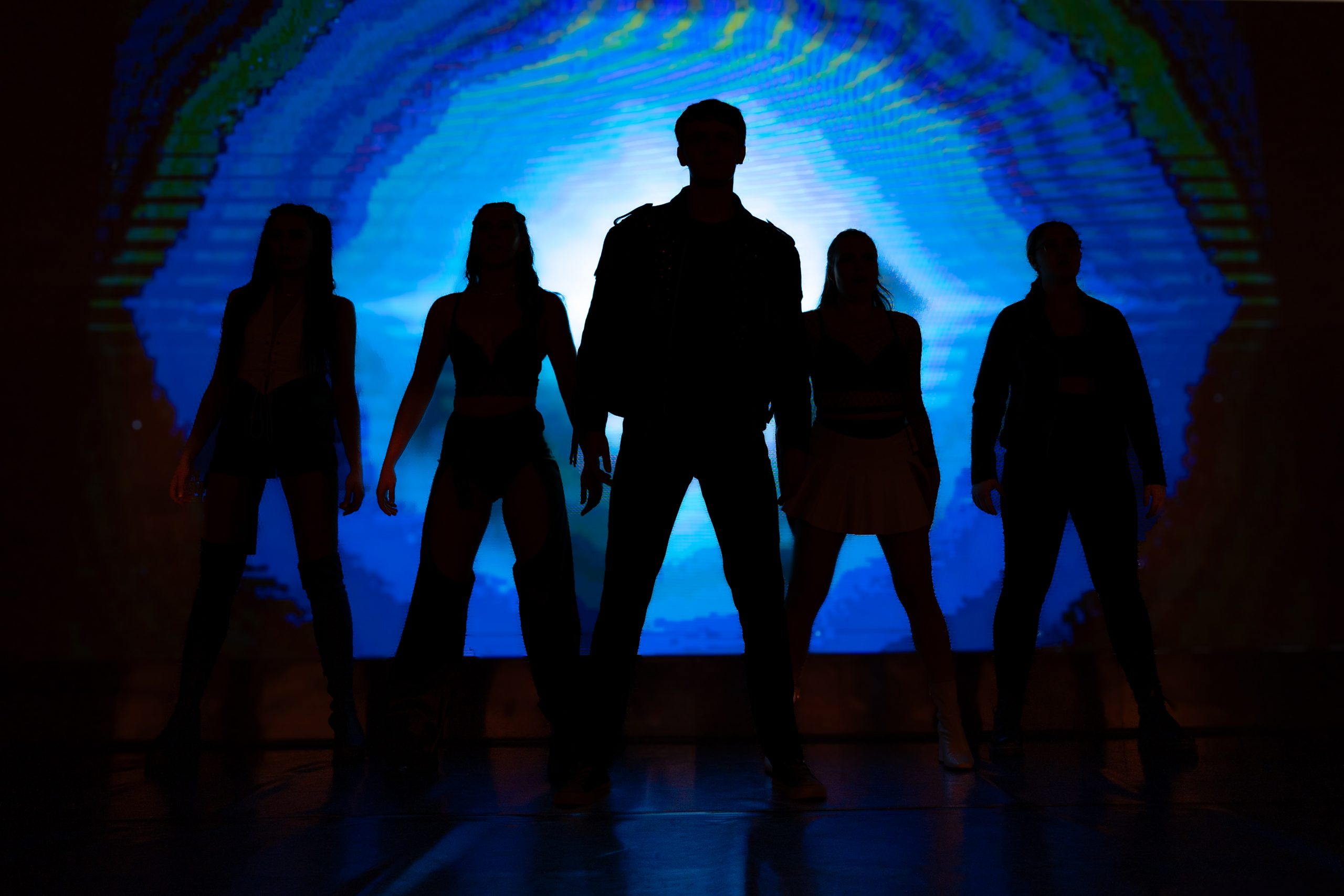 Students standing triumphantly on a stage