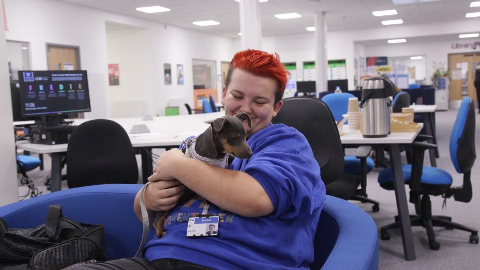 UCW student holding a puppy