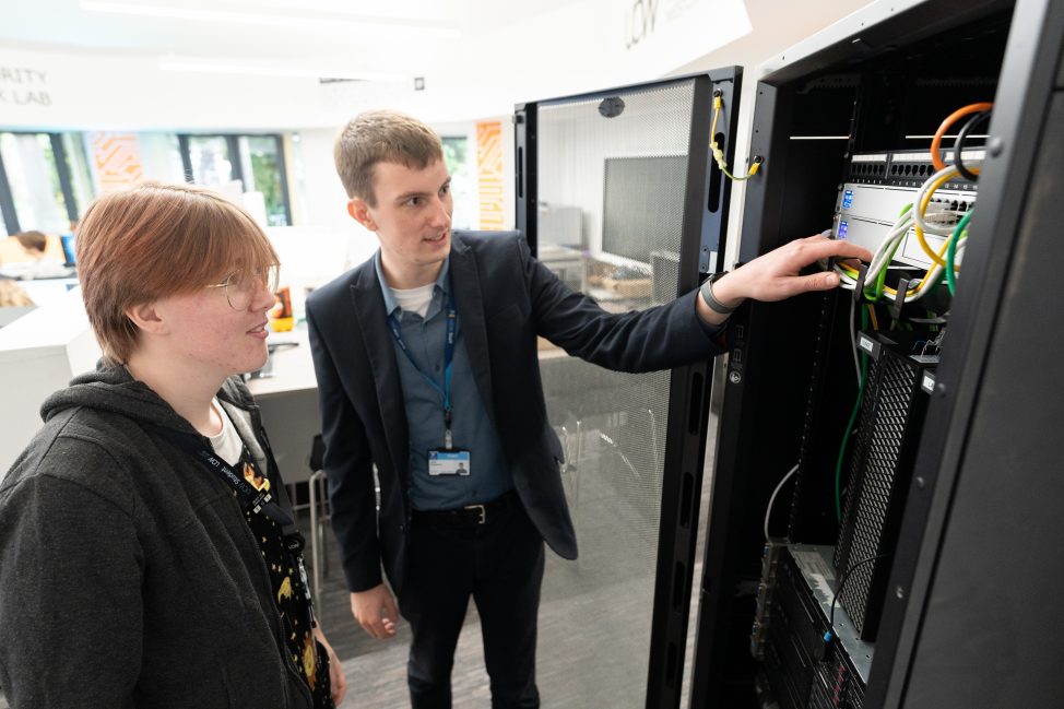 Jack showing a piece of equipment to a student