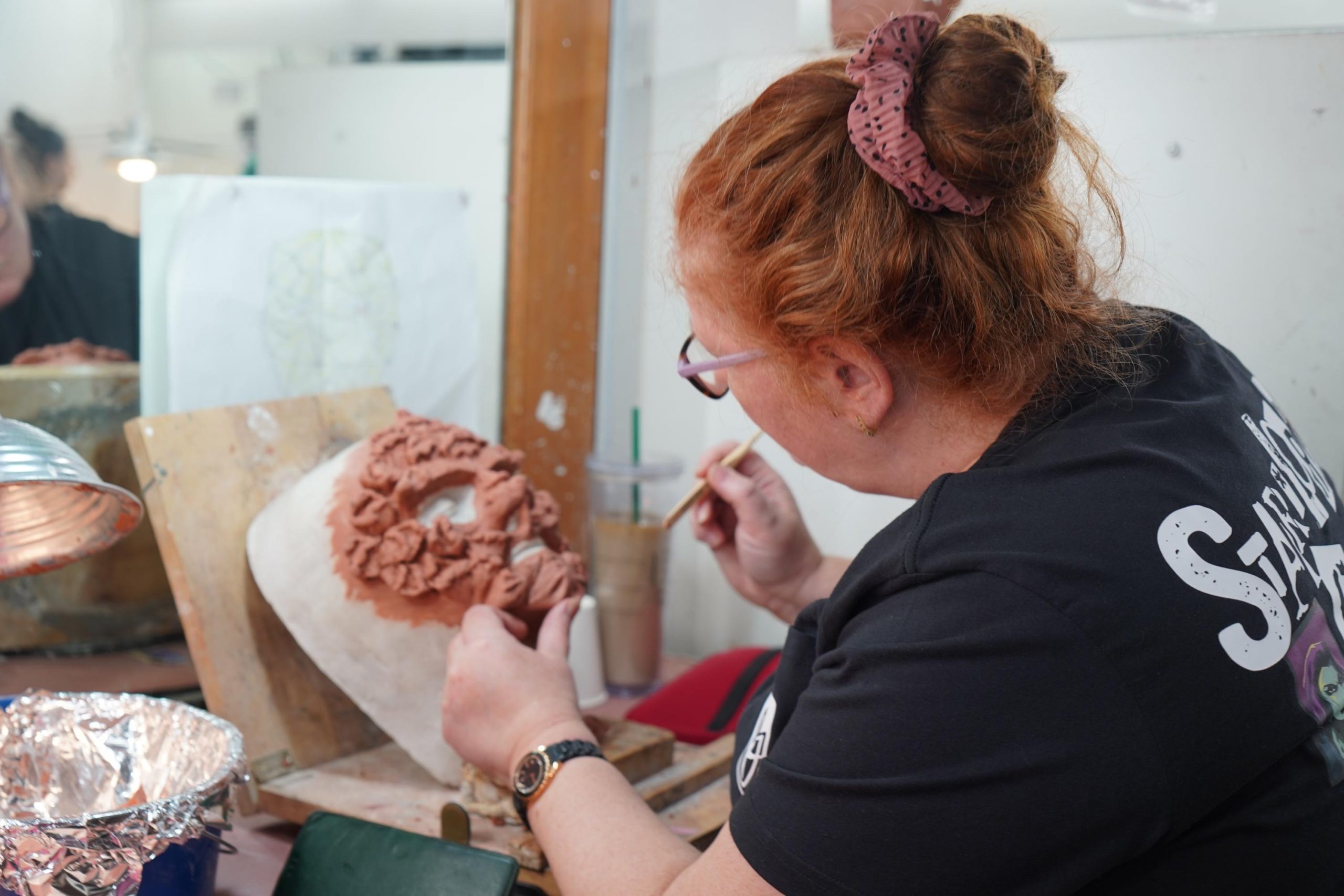 woman painting prosthetics