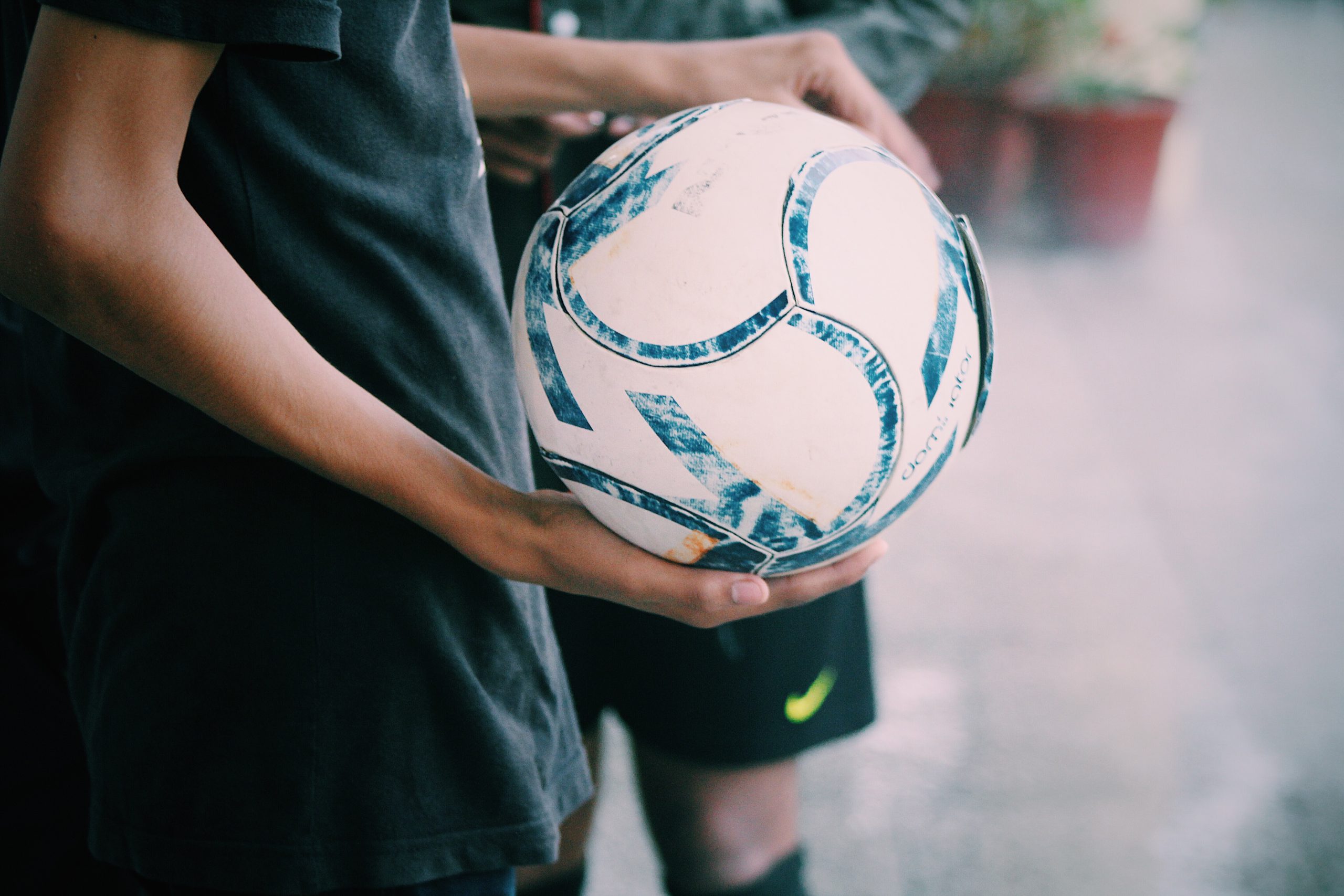 someone holding a football with one hand